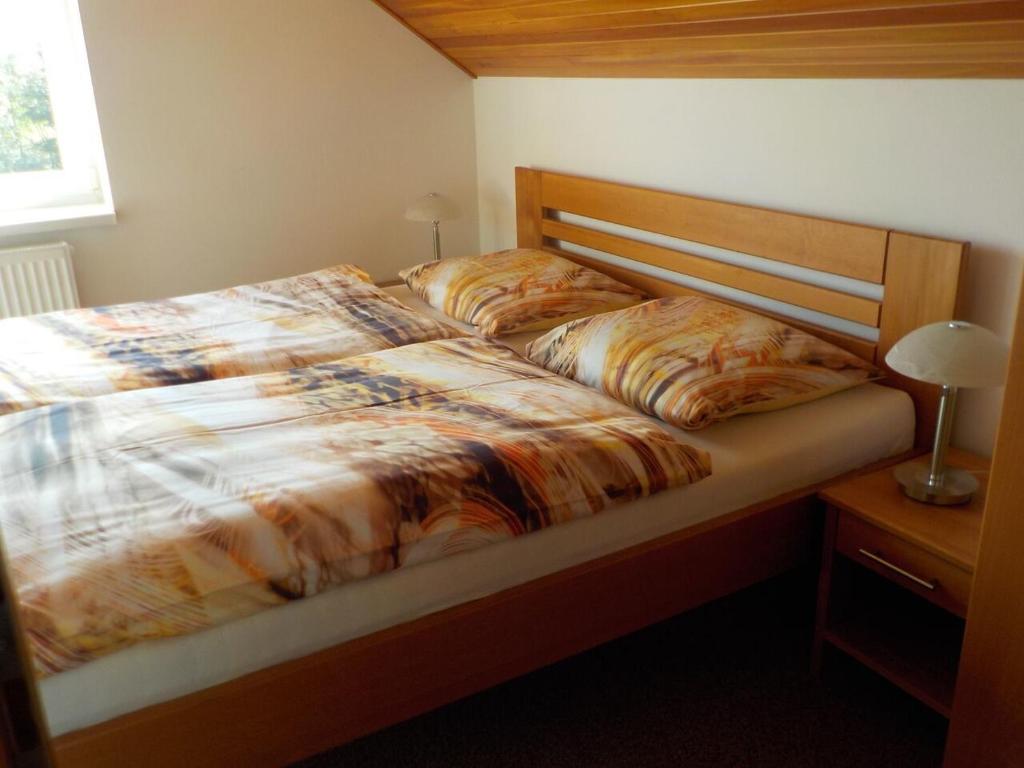 a bedroom with a large bed with a wooden headboard at Casa Maika in Frymburk