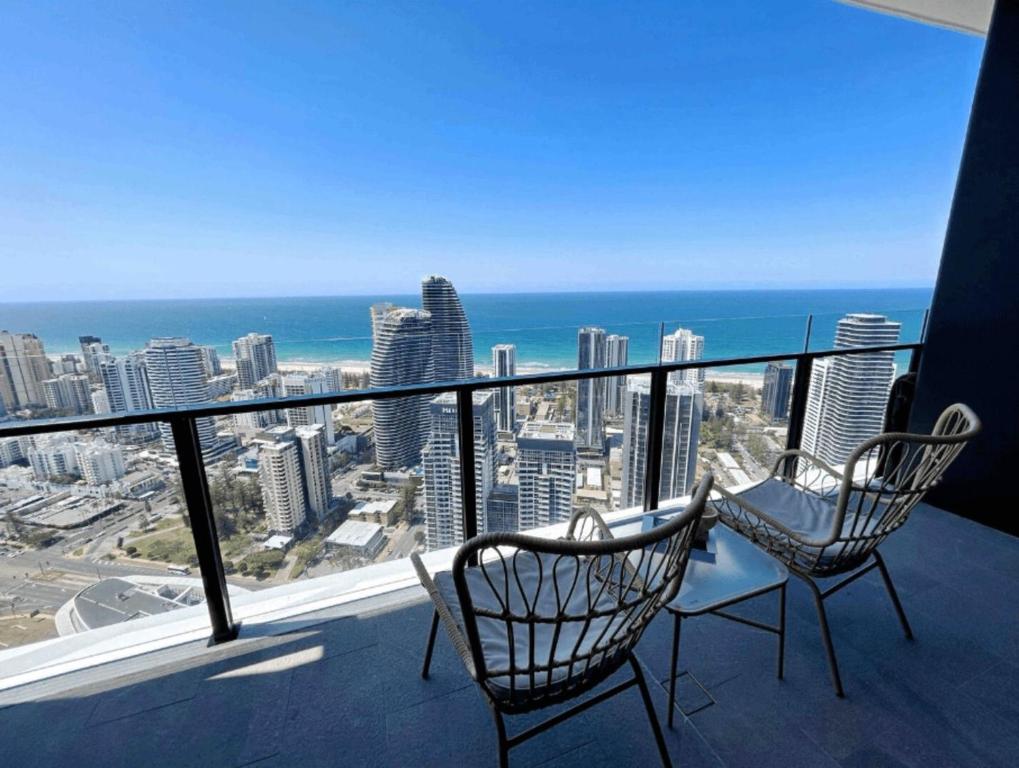 a balcony with two chairs and a view of the ocean at Magnificent Full Ocean View at Casino Free Parking in Gold Coast