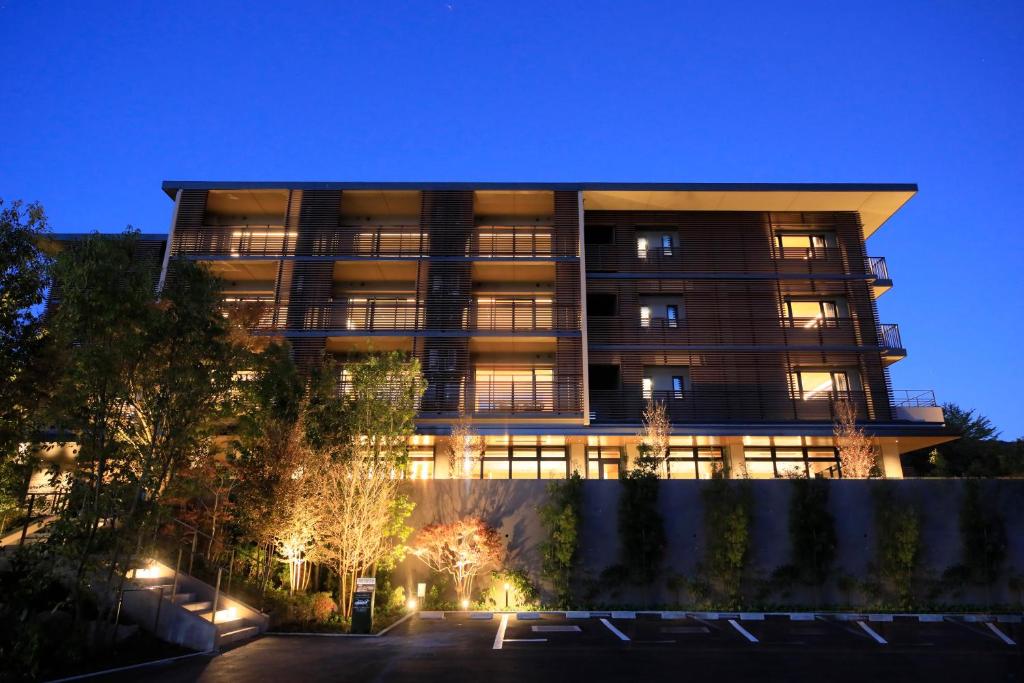 an apartment building at night with lights at BLISSTIA Hakone Sengokuhara in Hakone