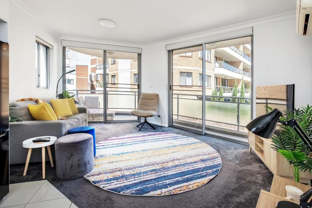 a living room with a couch and a rug at The Earl - Potts Point Paradise with Sydney Views in Sydney