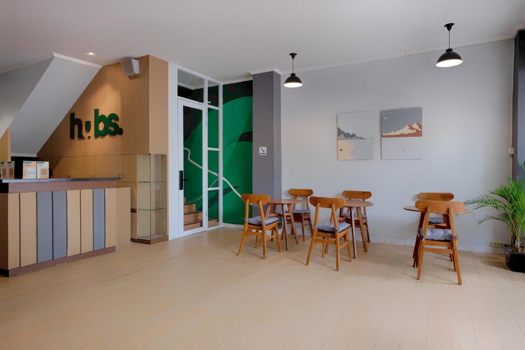 a restaurant with a table and chairs in a room at HUBS Hostel Yogyakarta in Yogyakarta