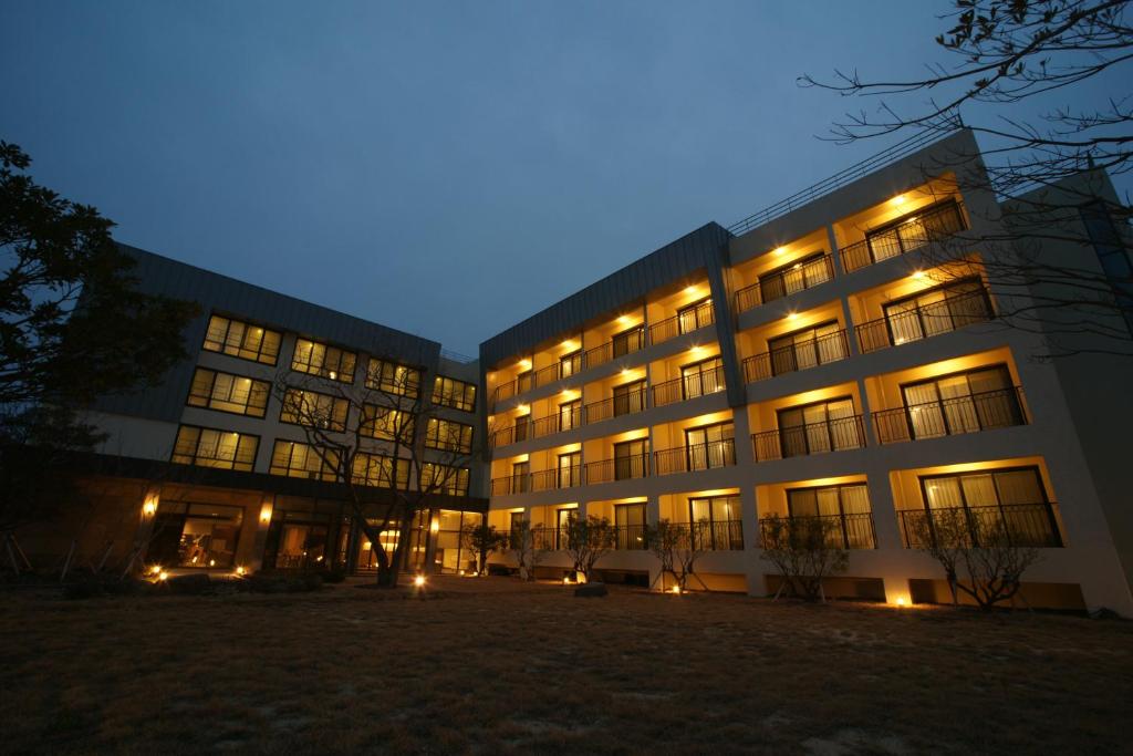 a large building at night with lights on at IlleInn Hotel in Seogwipo