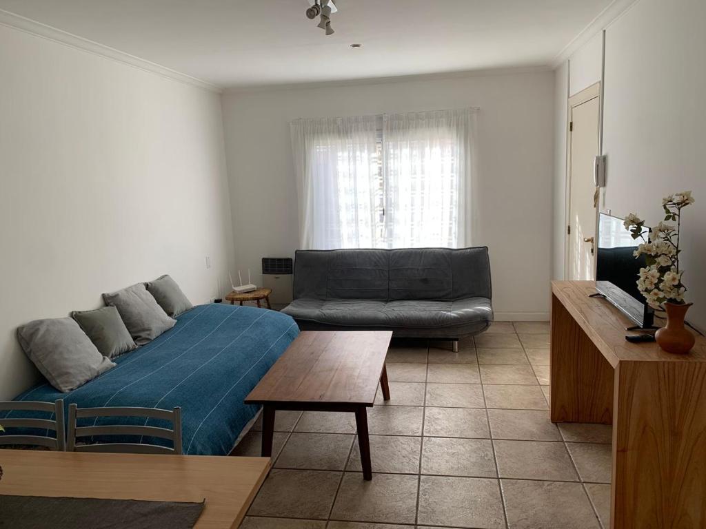 a living room with a couch and a table at Departamento quinta sección in Mendoza