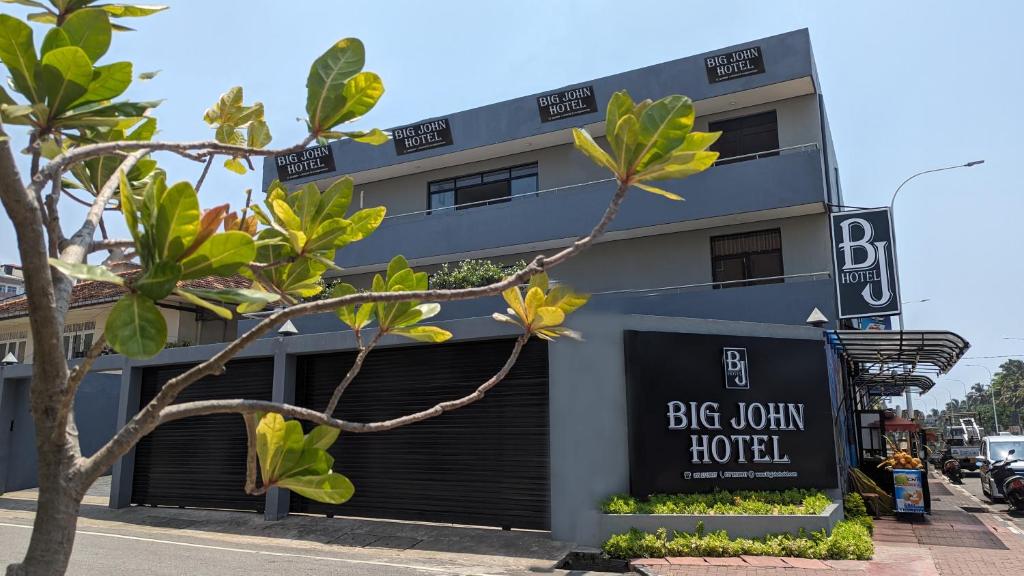 a building with a sign that reads big country hotel at Big John Hotel in Dehiwala