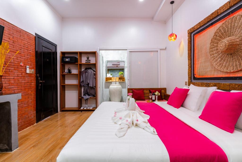 Postel nebo postele na pokoji v ubytování Angkor Rithy Boutiquese