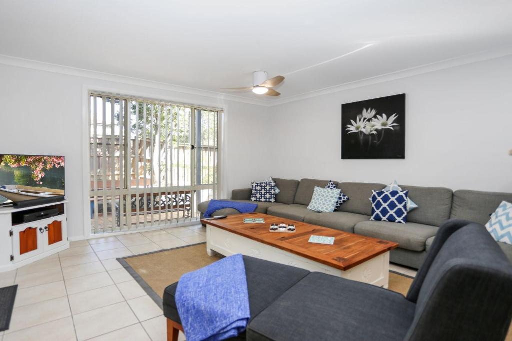 a living room with a couch and a table at Bennett's Beach House in Hawks Nest