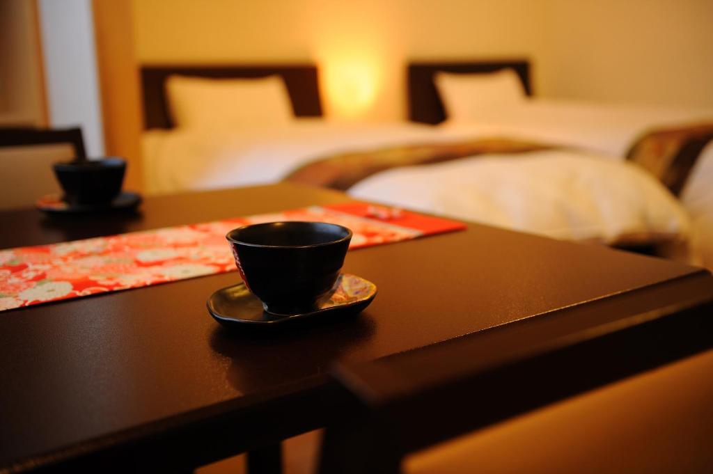 Postel nebo postele na pokoji v ubytování Suzukiya Ryokan