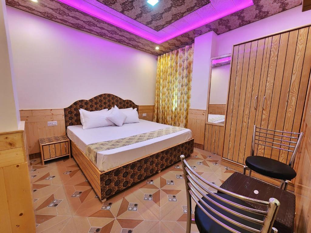 a bedroom with a bed and a chair in it at Mountain Mist Shimla in Shimla