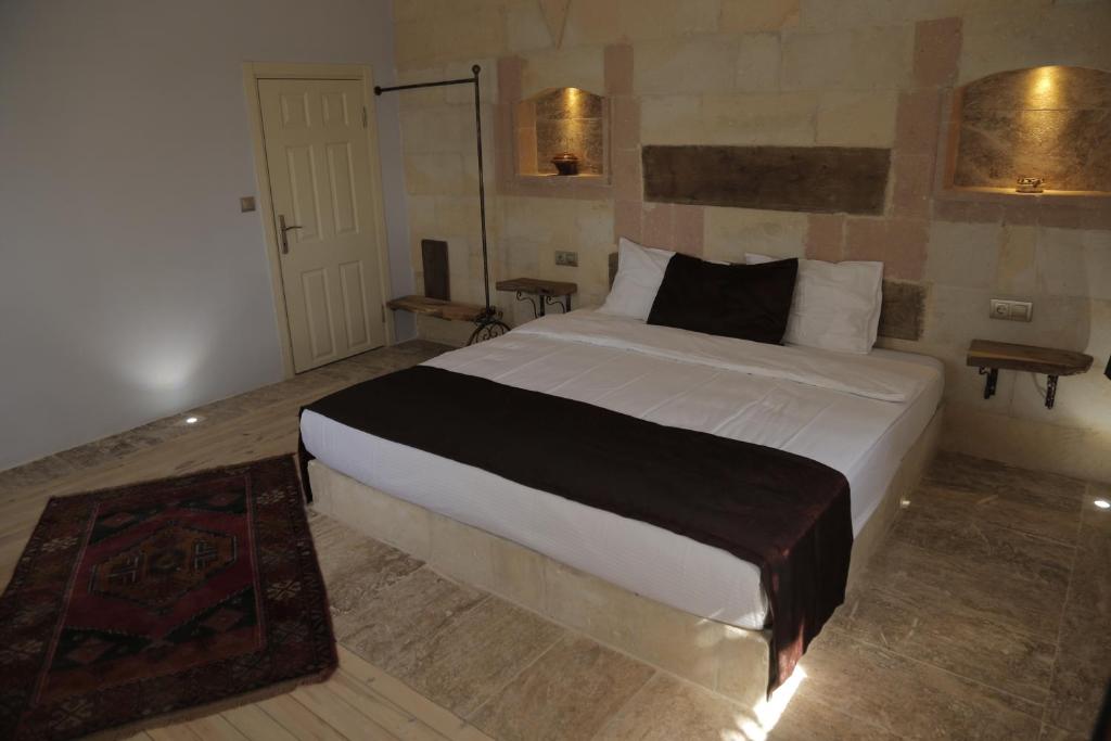 Postel nebo postele na pokoji v ubytování Philosophy Hotel