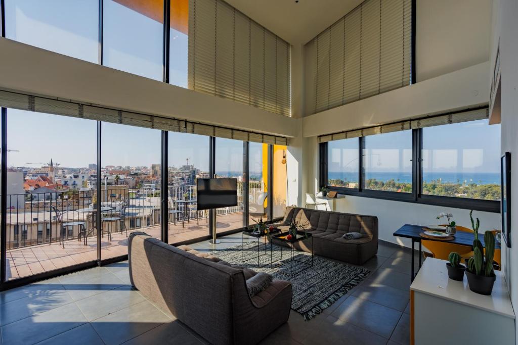 a living room with a view of a city at Elifelet Boutique By Nimizz in Tel Aviv