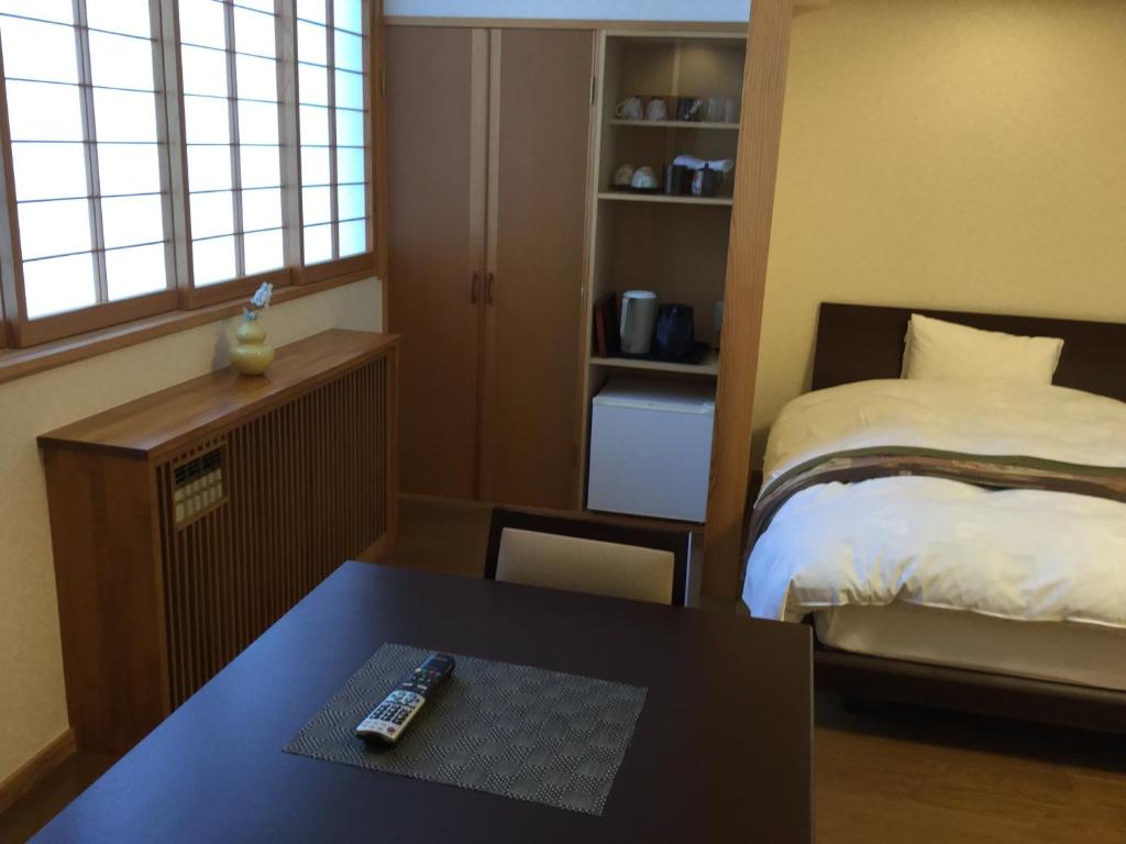 Postel nebo postele na pokoji v ubytování Suzukiya Ryokan