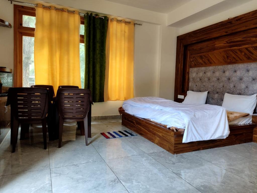 a bedroom with a bed and two chairs at Pranays House in Mumbai