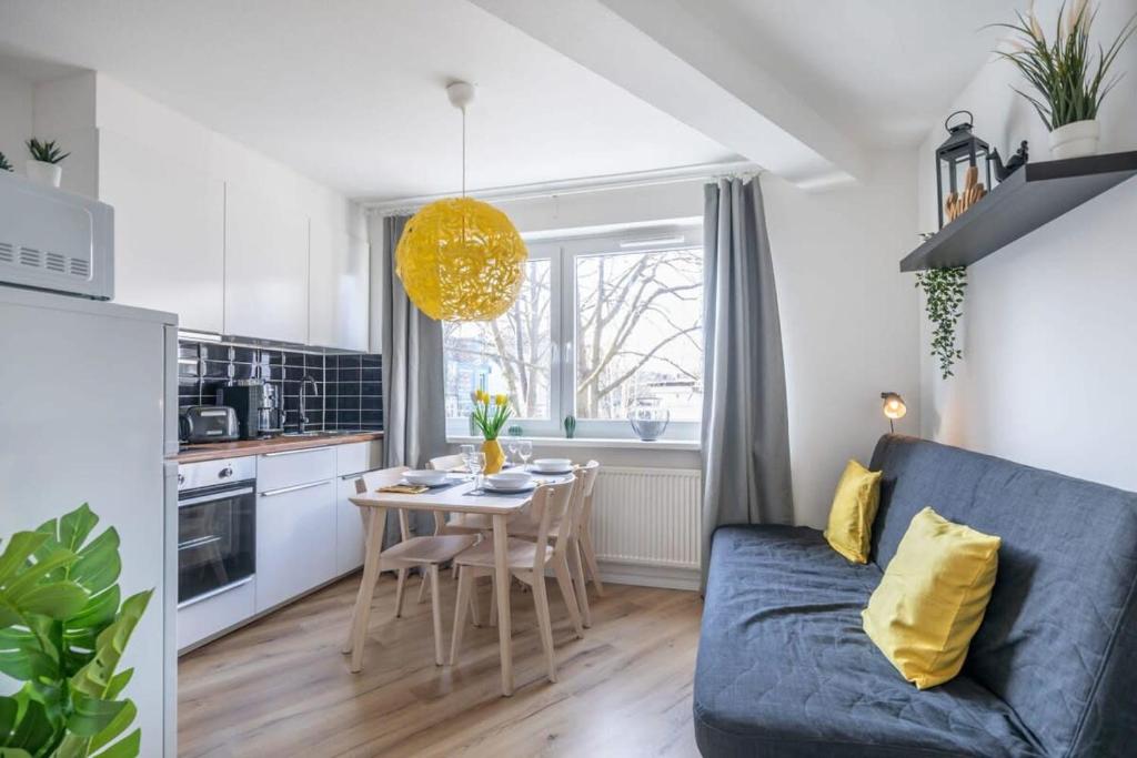 漢堡的住宿－Modern Apartment for 6 close to the Schanzenviertel - Unit 2，客厅配有蓝色的沙发和桌子