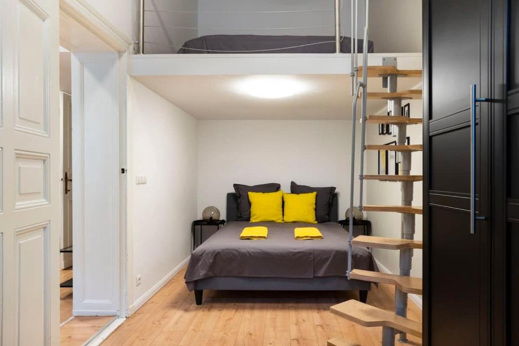 a bedroom with a bunk bed and a ladder at Loft Apart plus AC plus SelfCheckIn in Berlin