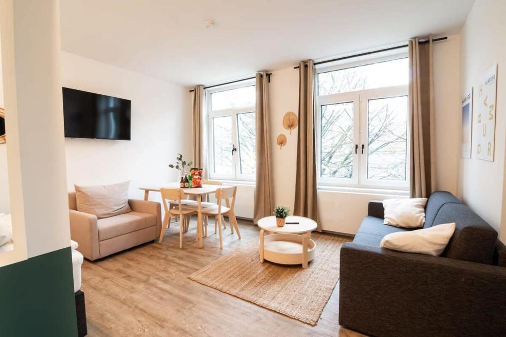 a living room with a couch and a table at Hamburg - Cosy Apartment for 4 in Hamburg
