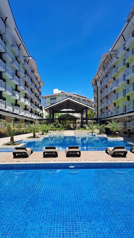 a large swimming pool in front of some buildings at Zhamira Avior's Condominium in Mactan