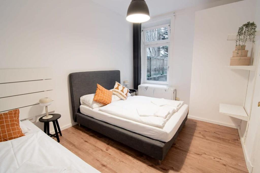 a small bedroom with a bed and a window at Great Three Bedroom Apartment in Hamburg