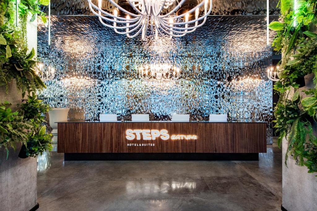 a lobby with a starbucks sign on the wall at STEPS Batumi Hotel & Suites in Batumi