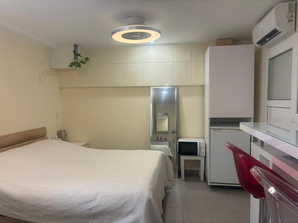 a small room with a bed and a kitchen at Small apartments in Lamone in Lamone