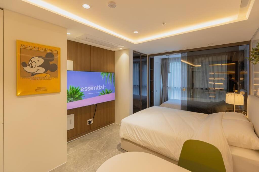 a bedroom with a bed and a flat screen tv at Wecostay Gangnam in Seoul