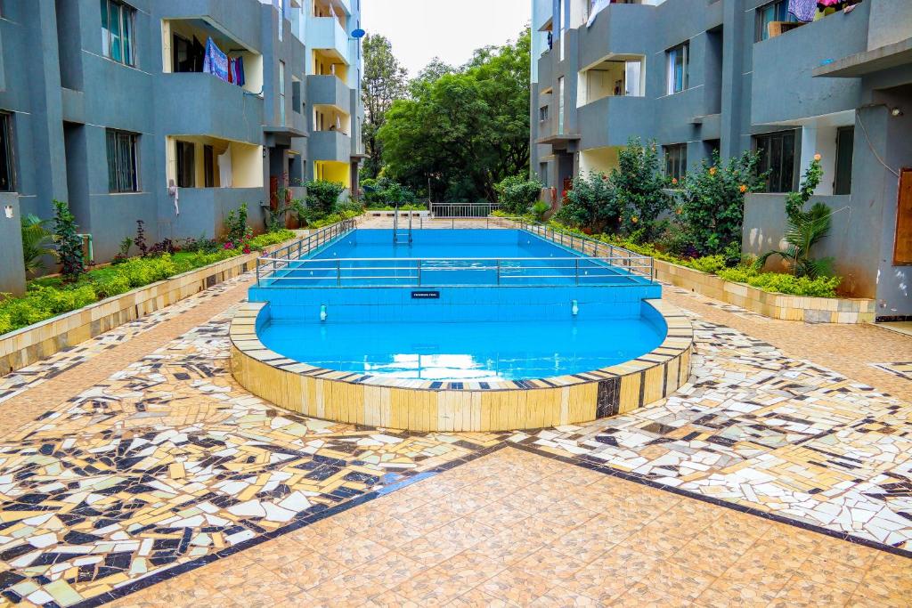 a swimming pool in the middle of a building at Spring Garden By Edmor Suites in Nairobi