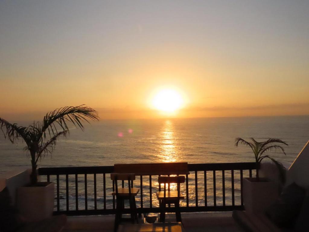 a sunset from the balcony of a resort at Oceanfront Greek Style Gem in Ballito