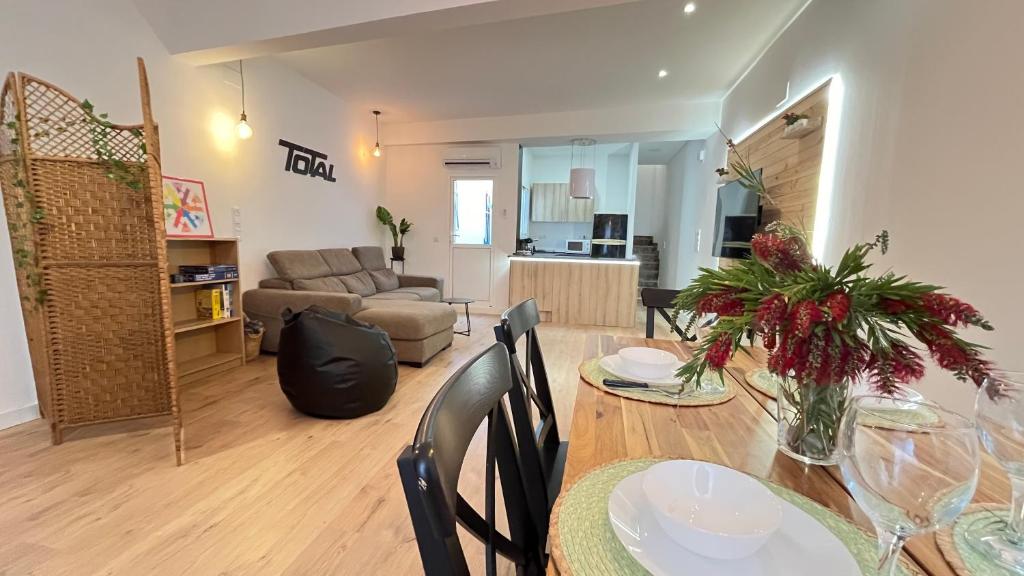 a dining room and living room with a table and chairs at La Casica de los Abuelos By El Conserje in Pedralba