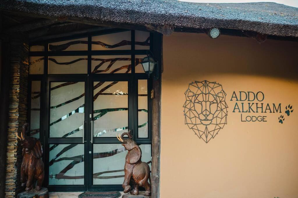 a building with a window with a animal on the wall at Addo Alkham Lodge in Sunland