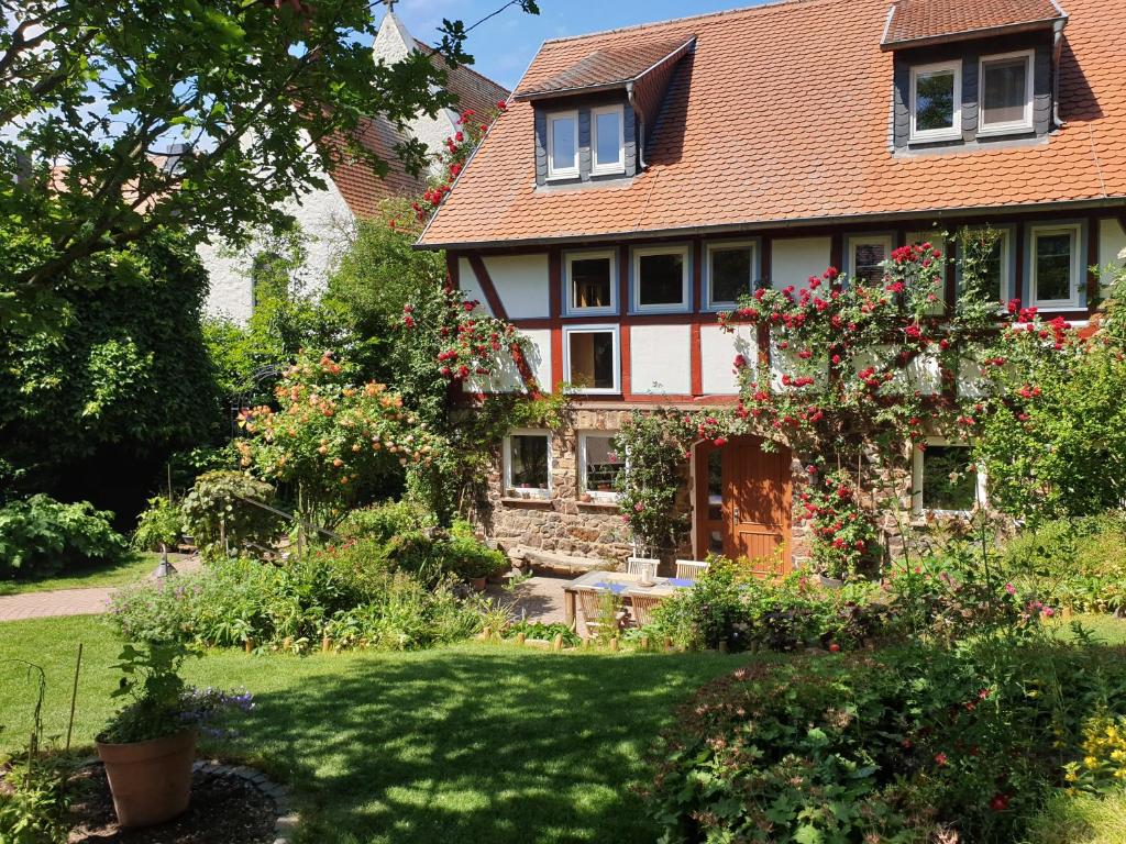 una casa con muchas flores en el patio en Ferienhaus Burgblick, en Münzenberg