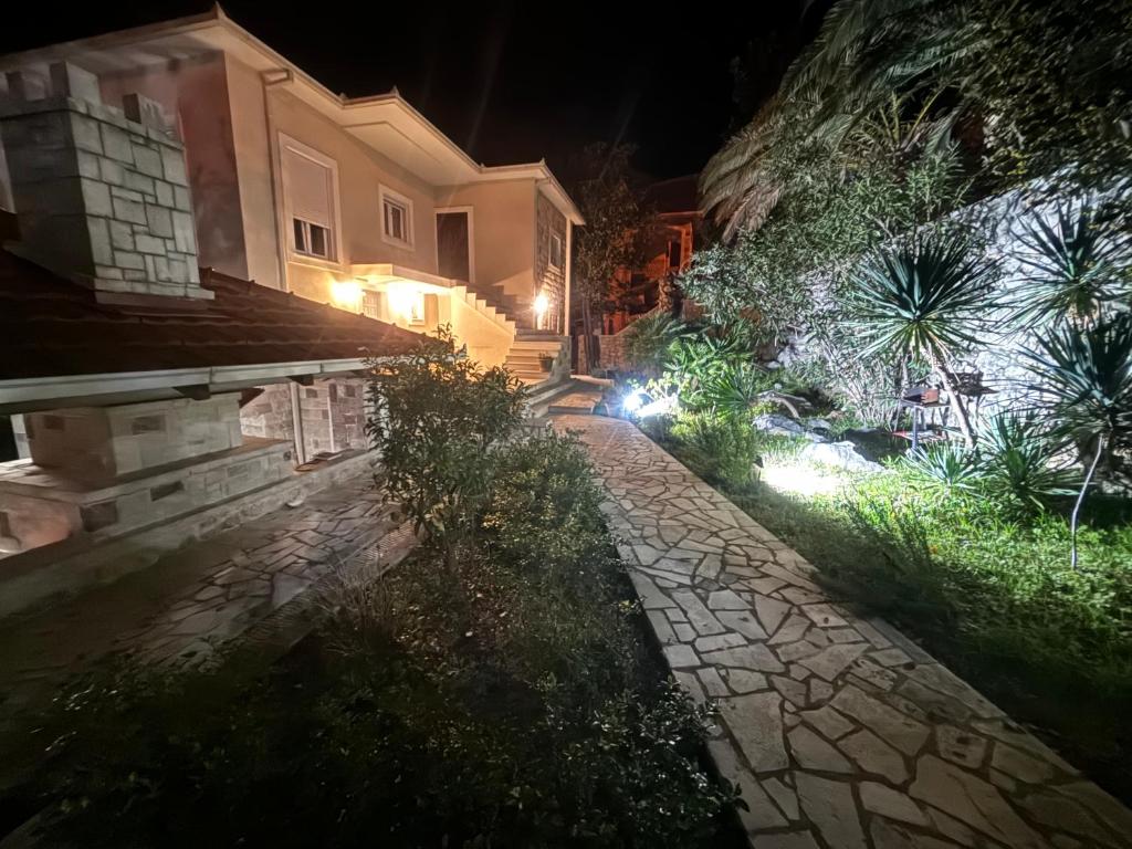 a stone path in front of a house at night at Stone Villa in Bečići