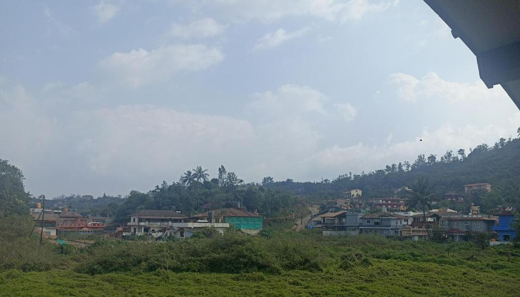 un grupo de casas en una colina en una ciudad en Misty Homes, en Madikeri