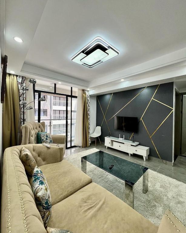 a living room with a couch and a tv at Easy spacious apartments in Durban