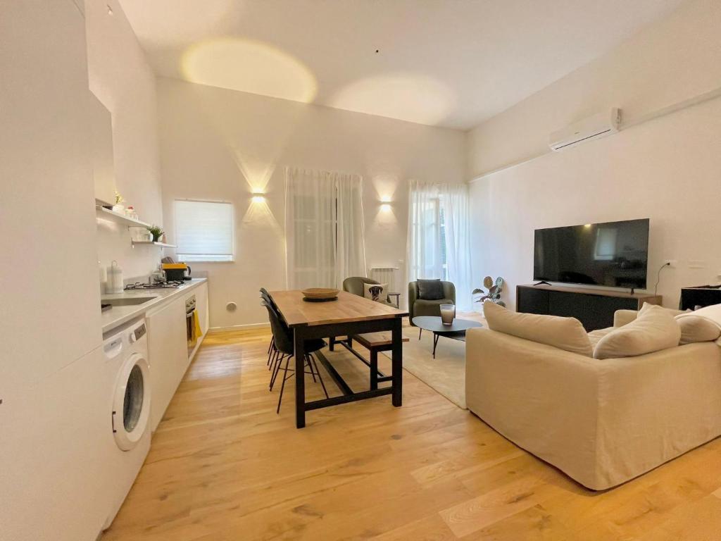 a living room with a table and a couch at I Marmi New Royal Design Apartment in Livorno