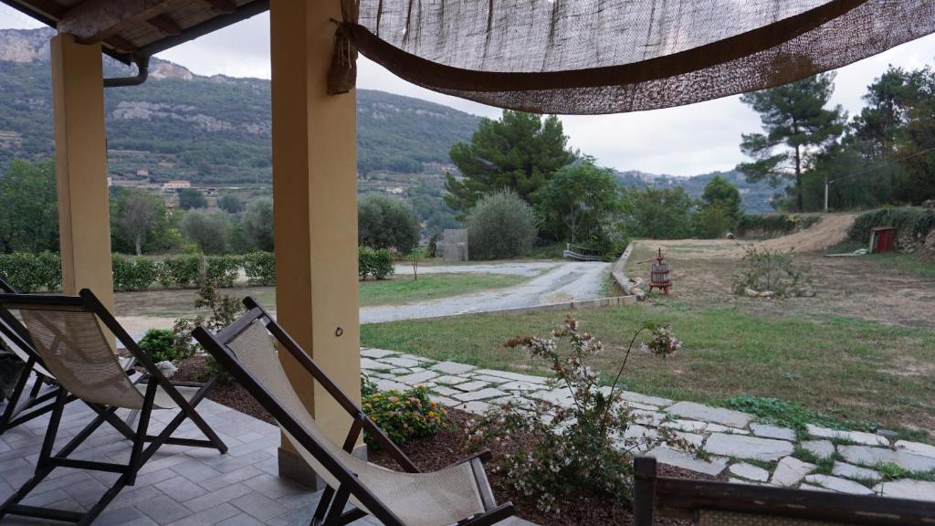 porche con 2 sillas y vistas a la carretera en I Campi di Lino, en Finale Ligure