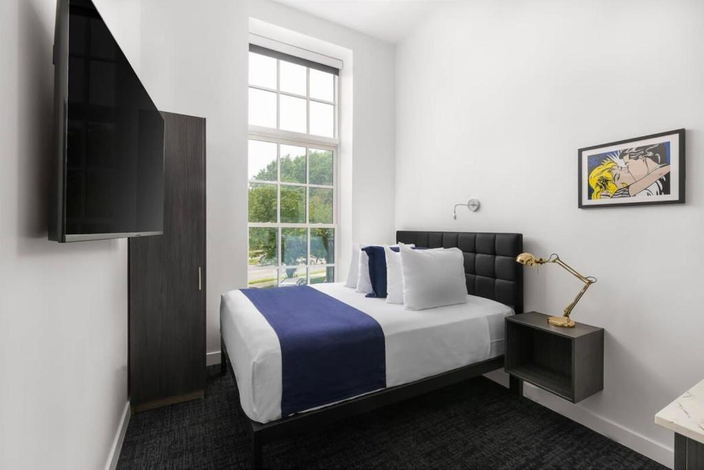 a hotel room with a bed and a window at Stylish Studio in Historic Boston - #206 in Boston