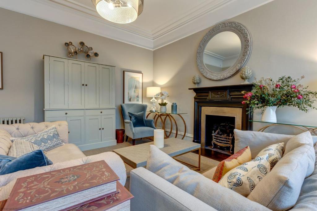 a living room with two couches and a fireplace at Rawlinson Road 10B in Oxford