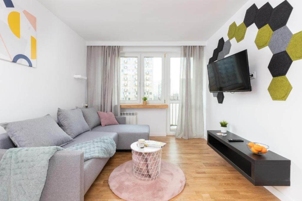 a living room with a couch and a tv at Apartament Pomorska in Gdańsk