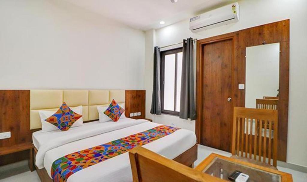 a bedroom with a large bed in a room at FabExpress Pravi Inn in Lucknow