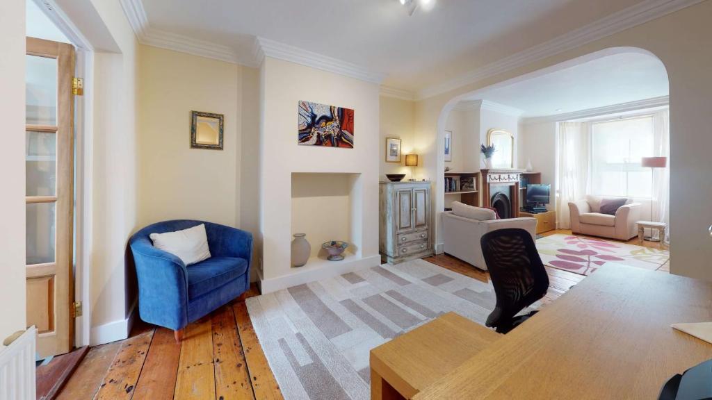 a living room with a blue chair and a table at Princes Street in Oxford