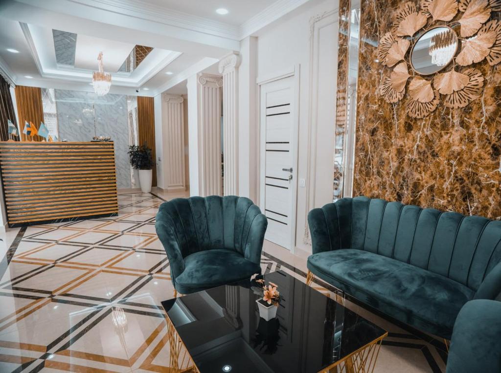 a lobby with two chairs and a mirror at Art Plaza Hotel in Tashkent