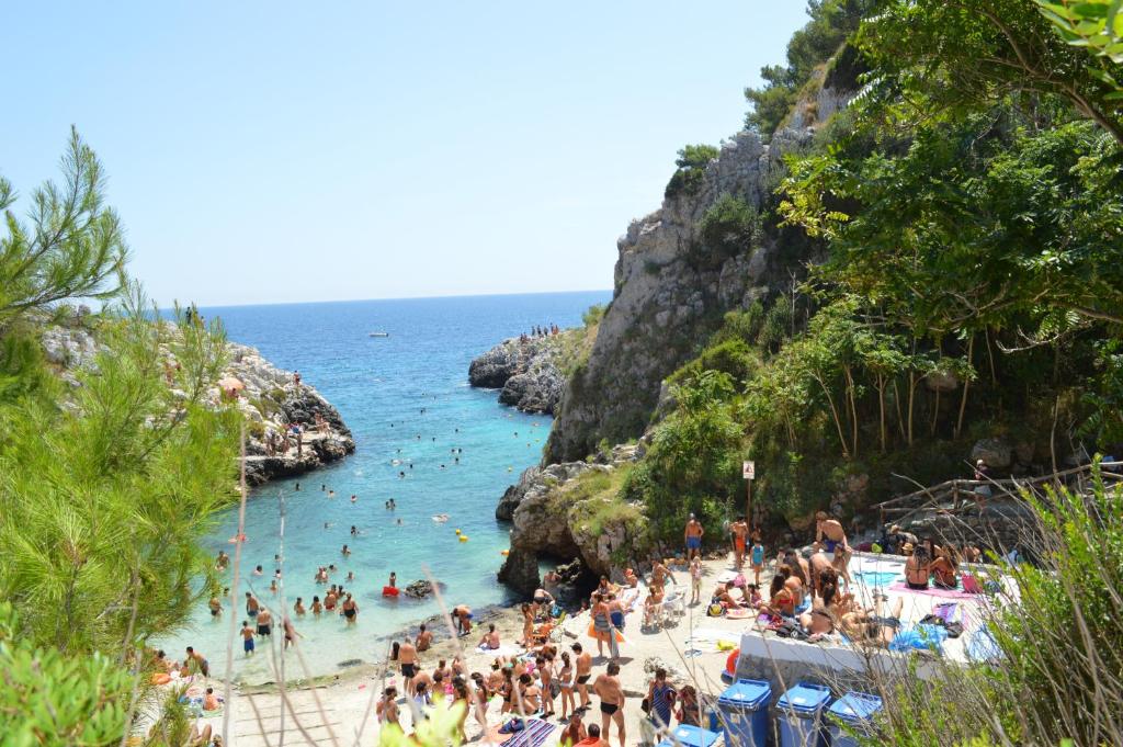 a group of people in the water at a beach at B&B Le Rose in Vignacastrisi