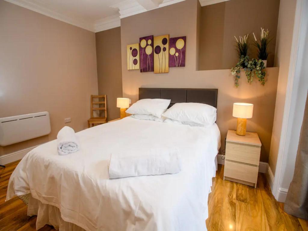 a bedroom with a large white bed with two pillows at Pass the Keys Brayford room at Tavmar Apartments in Lincoln