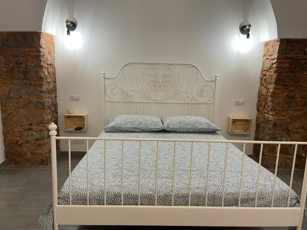 a bed with a white headboard in a room at Catania Centro Storico in Catania