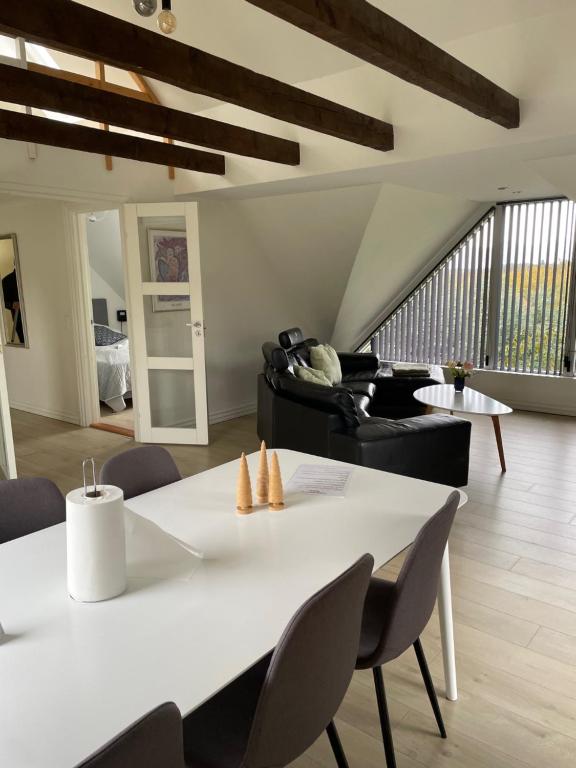 uma sala de estar com uma mesa branca e cadeiras em Søkig em Viborg