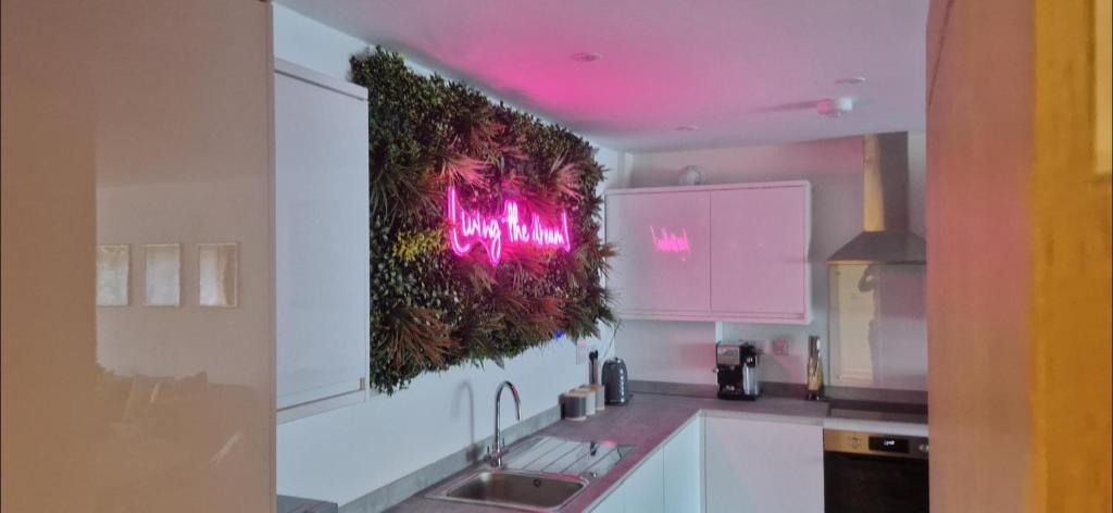 a kitchen with pink lights on the wall at No 4 Hawthorn Ground floor apartment in York