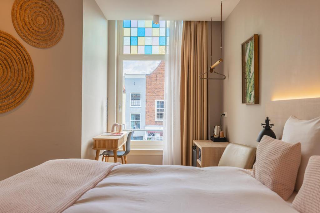 Een bed of bedden in een kamer bij City Hotel Rembrandt
