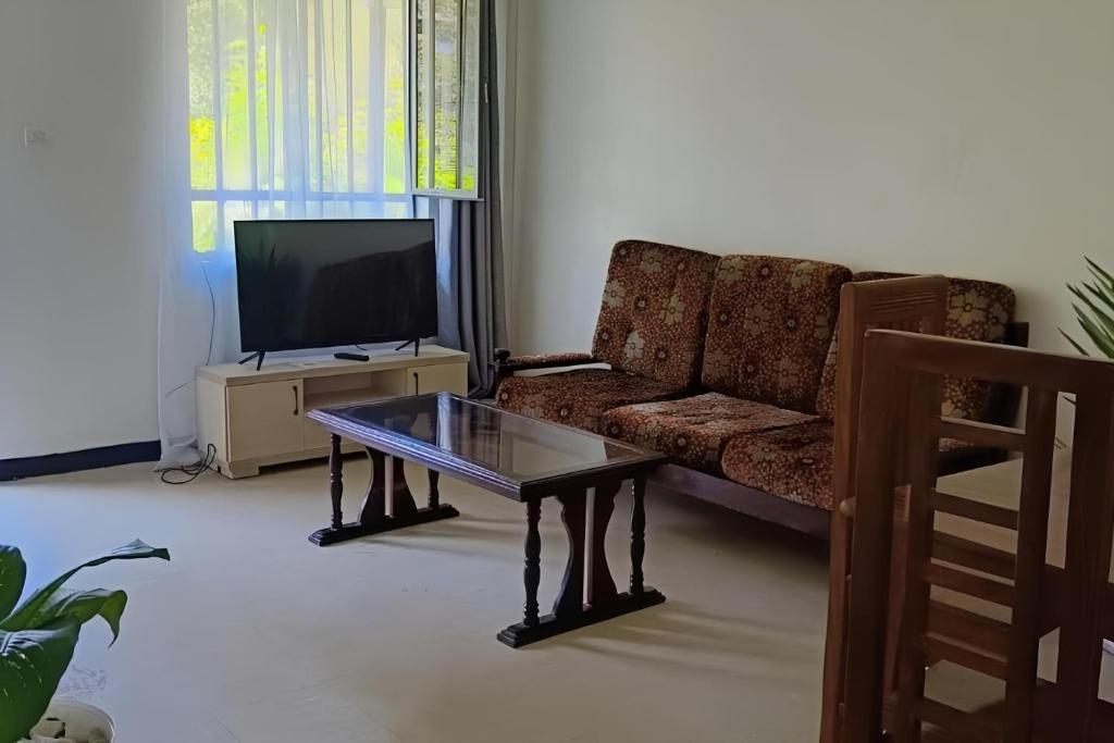 a living room with a couch and a coffee table at FevKoti in Addis Ababa