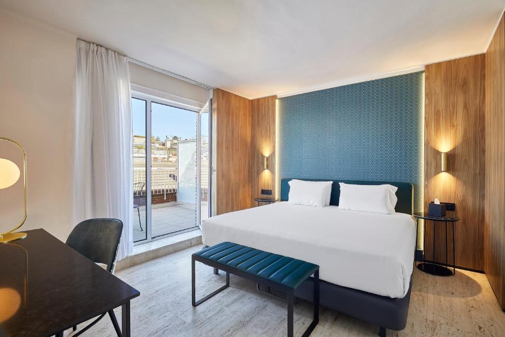 a bedroom with a large bed and a large window at Exe Mitre in Barcelona