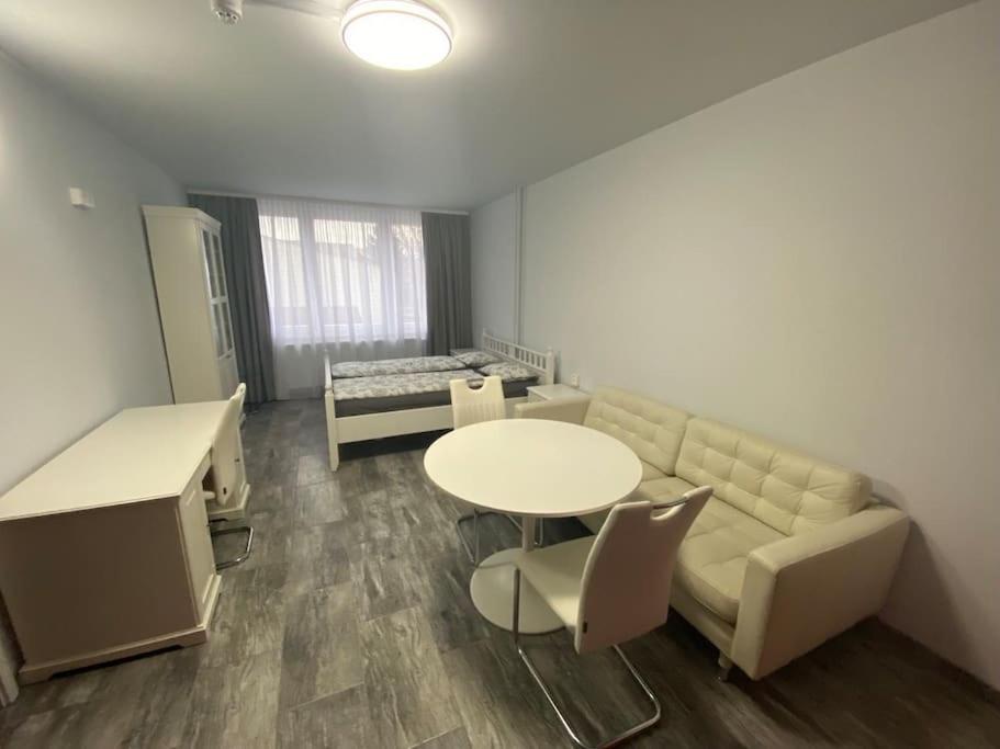 a living room with a couch and a table at Apartment Střížkov in Prague