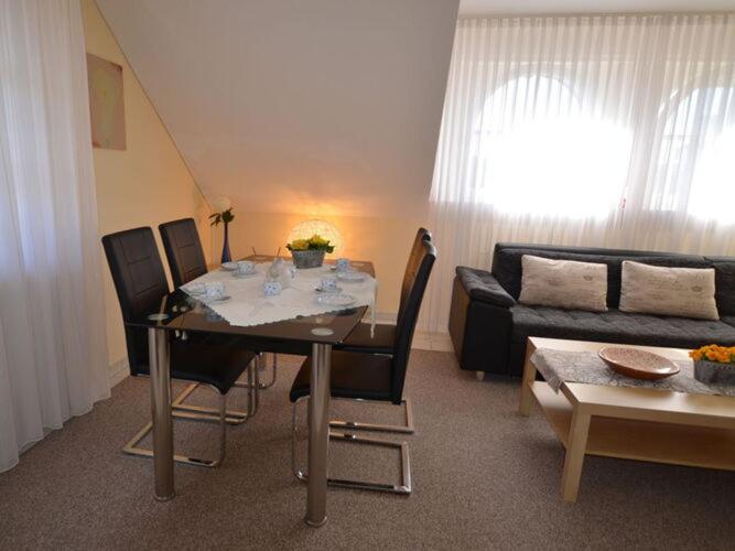 a living room with a table and a couch at Holiday apartment Kettler in Sassenberg
